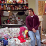 A man standing in front of an organized living room.