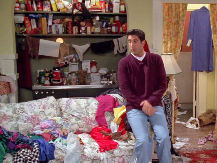 A man standing in front of an organized living room.