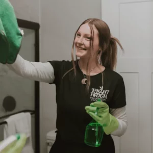 Woman cleaning technician wiping mirror